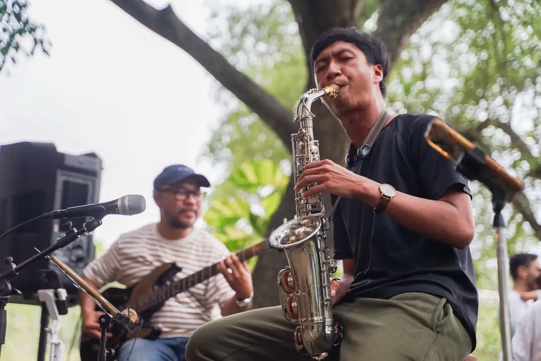 A band playing under the trees at Banyoo, saxophone in front